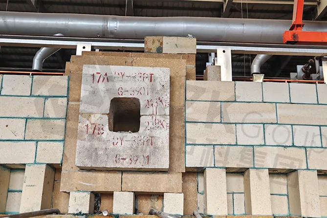 Burner port block set into the side wall. The opening has to hold its shape through the campaign so the flame pattern stays as designed.