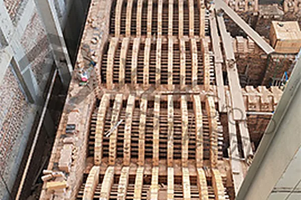 Port crown arches under construction — each port is arched independently so thermal movement stays local.