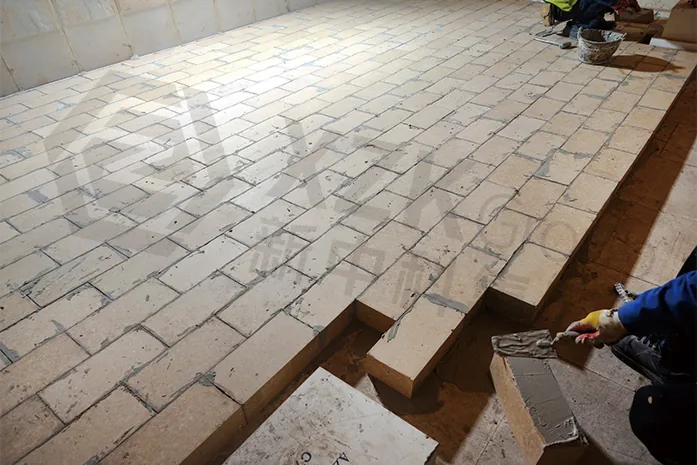 Tank bottom paving — bricks laid to a staggered pattern over the rammed sealing layer.