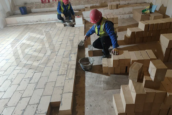 Paving crew at work on the tank bottom. Joint tightness here is what decides whether upward drilling can start.